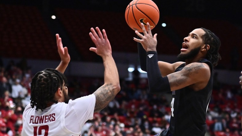 Feb 23, 2022; Pullman, Washington, USA; Washington Huskies guard PJ Fuller (4) shoots the ball against Washington State Cougars guard Michael Flowers (12) in the first half at Friel Court at Beasley Coliseum. Mandatory Credit: James Snook-USA TODAY Sports