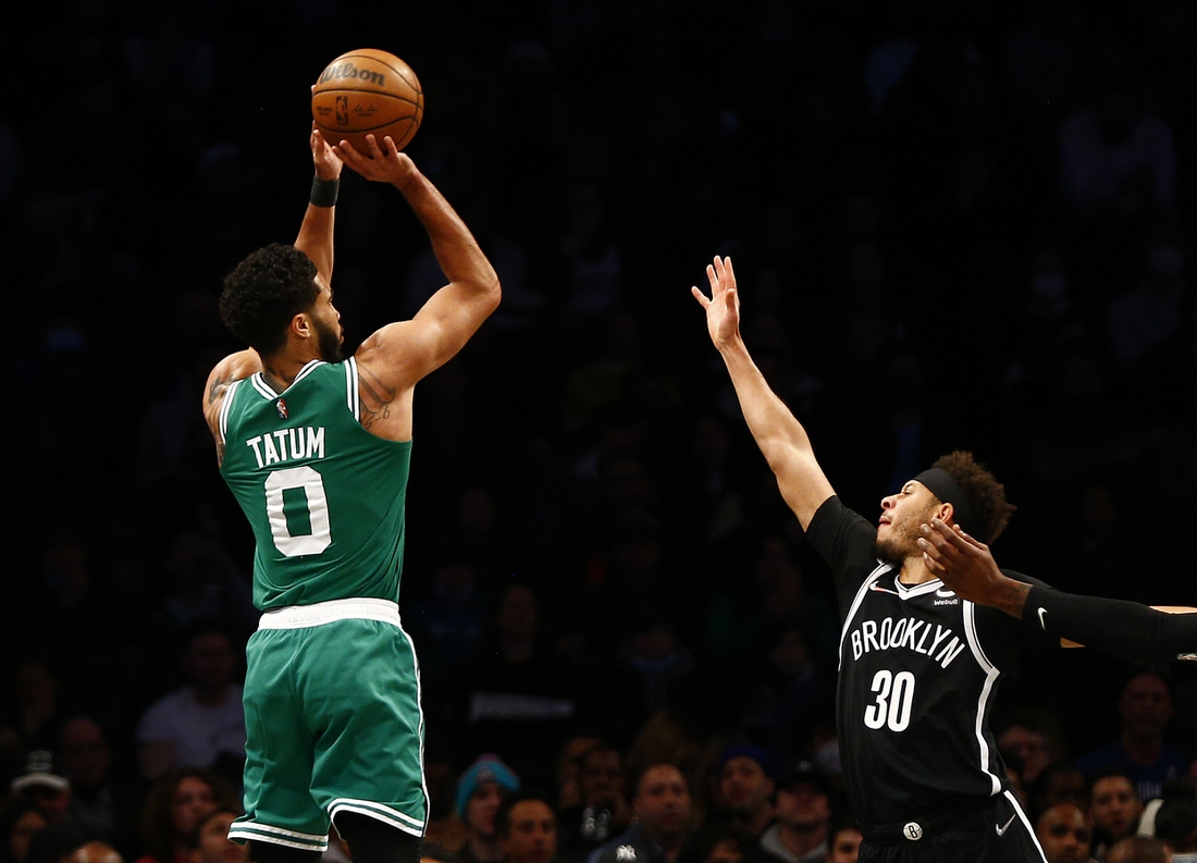 Feb. 24, 2022 ; Brooklyn, New York, USA; Boston Celtics forward Jayson Tatum (0) shoots while being defended by Brooklyn Nets guard Seth Curry (30) during the first half at Barclays Center. Mandatory Credit: Andy Marlin-USA TODAY Sports