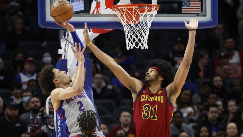 Feb 24, 2022; Detroit, Michigan, USA;  Detroit Pistons guard Cade Cunningham (2) shoots over Cleveland Cavaliers center Jarrett Allen (31) in the first half at Little Caesars Arena. Mandatory Credit: Rick Osentoski-USA TODAY Sports