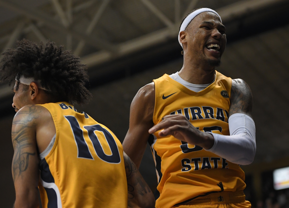 Feb 24, 2022; Murray, Kentucky, USA;  Murray State Racers guard Tevin Brown (10) and forward DJ Burns (55) celebrate a 3 pt shot from guard Rod Thomas (25) against the Belmont Bruins during second half at CFSB Center. Mandatory Credit: Steve Roberts-USA TODAY Sports