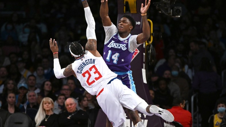 Feb 25, 2022; Los Angeles, California, USA;   Los Angeles Lakers forward Stanley Johnson (14) blocks a shot by Los Angeles Clippers forward Robert Covington (23) in the first half of the game at Crypto.com Arena. Mandatory Credit: Jayne Kamin-Oncea-USA TODAY Sports