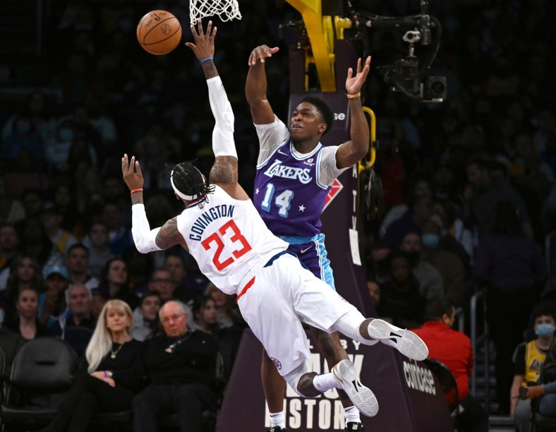 Feb 25, 2022; Los Angeles, California, USA;   Los Angeles Lakers forward Stanley Johnson (14) blocks a shot by Los Angeles Clippers forward Robert Covington (23) in the first half of the game at Crypto.com Arena. Mandatory Credit: Jayne Kamin-Oncea-USA TODAY Sports