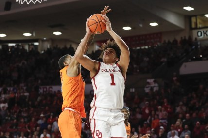 Feb 26, 2022; Norman, Oklahoma, USA; Oklahoma Sooners forward Jalen Hill (1) shoots as Oklahoma State Cowboys guard Rondel Walker (5) defends during the second half at Lloyd Noble Center. Oklahoma won 66-62 in ovetime. Mandatory Credit: Alonzo Adams-USA TODAY Sports