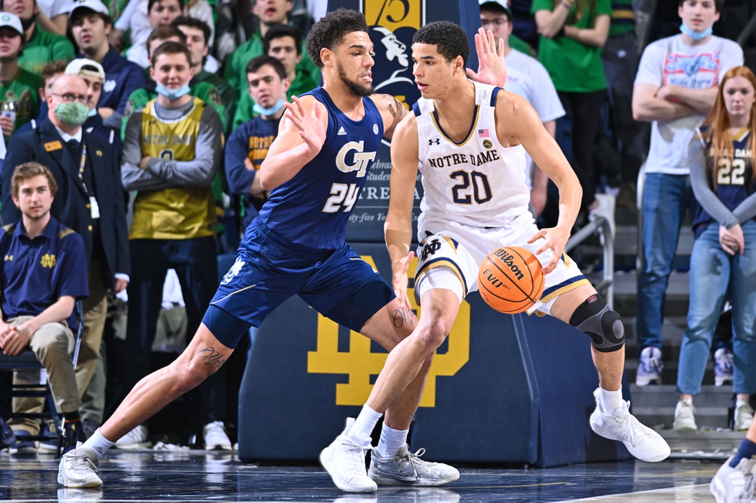 Feb 26, 2022; South Bend, Indiana, USA; Notre Dame Fighting Irish forward Paul Atkinson Jr. (20) dribbles as Georgia Tech Yellow Jackets center Rodney Howard (24) defends in the first half at the Purcell Pavilion. Mandatory Credit: Matt Cashore-USA TODAY Sports