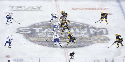 Feb 26, 2022; Nashville, Tennessee, USA; Nashville Predators left wing Tanner Jeannot (84) and Tampa Bay Lightning center Brayden Point (21) face off during the first in a Stadium Series ice hockey game at Nissan Stadium. Mandatory Credit: Steve Roberts-USA TODAY Sports