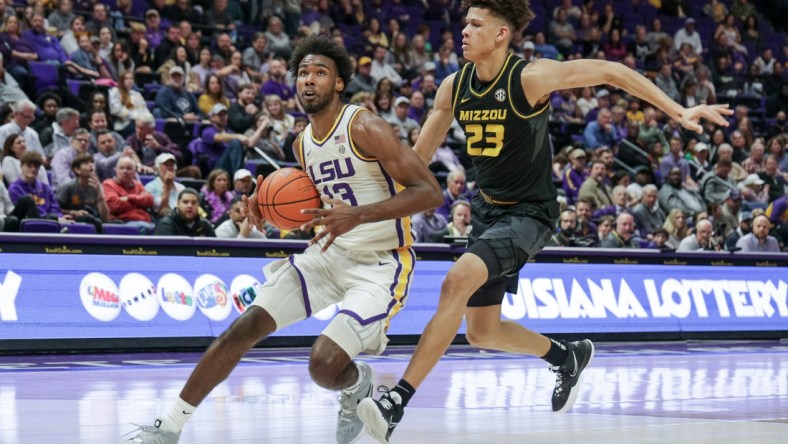 Feb 26, 2022; Baton Rouge, Louisiana, USA;  LSU Tigers forward Tari Eason (13) drives to the basket against Missouri Tigers forward Trevon Brazile (23) during the first half at the Pete Maravich Assembly Center. Mandatory Credit: Stephen Lew-USA TODAY Sports