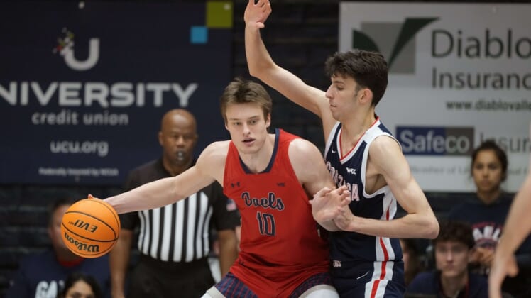 Feb 26, 2022; Moraga, California, USA; Saint Mary's Gaels center Mitchell Saxen (10) handles the ball while being defended by Gonzaga Bulldogs center Chet Holmgren (34) during the first half at University Credit Union Pavilion. Mandatory Credit: Darren Yamashita-USA TODAY Sports