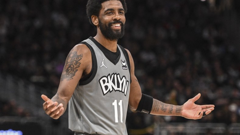 Feb 26, 2022; Milwaukee, Wisconsin, USA; Brooklyn Nets guard Kyrie Irving (11) reacts in the fourth quarter against the Milwaukee Bucks at Fiserv Forum. Mandatory Credit: Benny Sieu-USA TODAY Sports