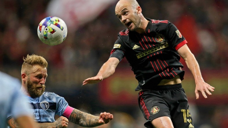 Feb 27, 2022; Atlanta, Georgia, USA; Sporting Kansas City midfielder Oriol Rosell (6) battles for the ball against Atlanta United defender Andrew Gutman (15) during the first half at Mercedes-Benz Stadium. Mandatory Credit: Brett Davis-USA TODAY Sports