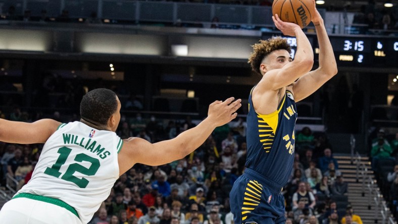 Feb 27, 2022; Indianapolis, Indiana, USA; Indiana Pacers guard Chris Duarte (3) shoots the ball while Boston Celtics forward Grant Williams (12) defends in the first half at Gainbridge Fieldhouse. Mandatory Credit: Trevor Ruszkowski-USA TODAY Sports