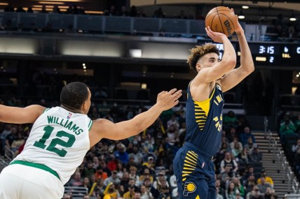 Feb 27, 2022; Indianapolis, Indiana, USA; Indiana Pacers guard Chris Duarte (3) shoots the ball while Boston Celtics forward Grant Williams (12) defends in the first half at Gainbridge Fieldhouse. Mandatory Credit: Trevor Ruszkowski-USA TODAY Sports