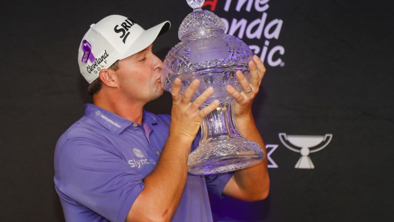 Feb 27, 2022; Palm Beach Gardens, Florida, USA; Sepp Straka kisses The Honda Classic trophy after winning The Honda Classic golf tournament. Mandatory Credit: Sam Navarro-USA TODAY Sports