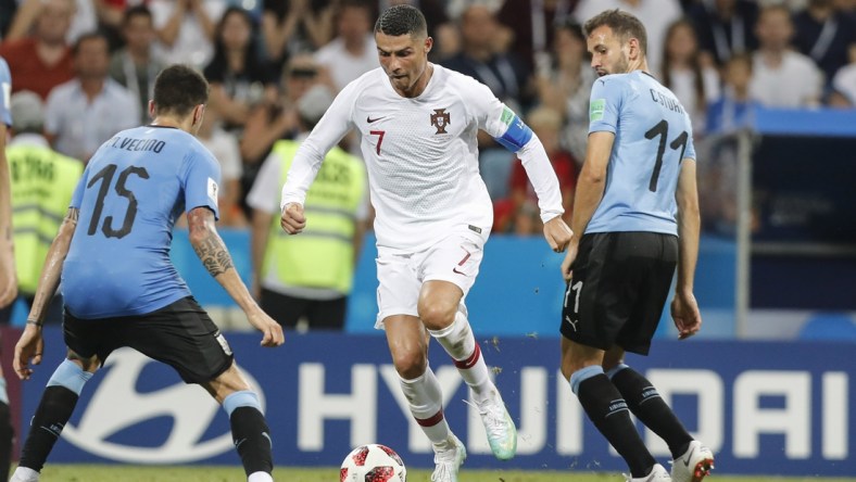 Jun 30, 2018; Sochi, Russia; Portugal player Cristiano Ronaldo (7) controls the ball against Uruguay players Cristhian Stuani (11) and Matias Vecino (15) in the round of 16 during the FIFA World Cup 2018 at Fihst Stadium. Mandatory Credit: Leonel de Castro/Global Images/Sipa USA via USA TODAY Sports