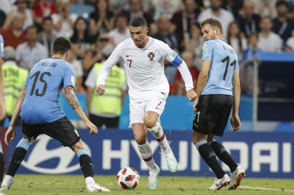 Jun 30, 2018; Sochi, Russia; Portugal player Cristiano Ronaldo (7) controls the ball against Uruguay players Cristhian Stuani (11) and Matias Vecino (15) in the round of 16 during the FIFA World Cup 2018 at Fihst Stadium. Mandatory Credit: Leonel de Castro/Global Images/Sipa USA via USA TODAY Sports