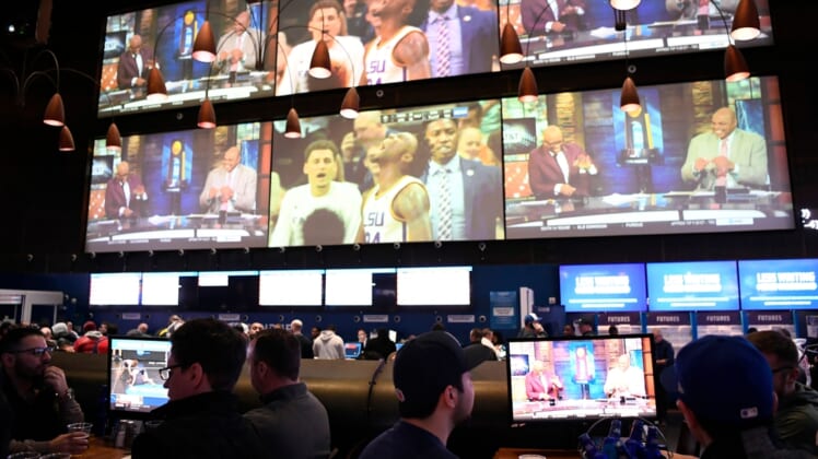 Sports fans bet and watch the first games of the NCAA basketball tournament at the Meadowlands Racetrack on Thursday, March 21, 2019, in East Rutherford.Meadowlands March Madness Gambling