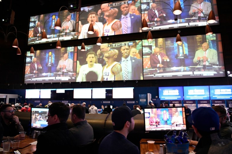 Sports fans bet and watch the first games of the NCAA basketball tournament at the Meadowlands Racetrack on Thursday, March 21, 2019, in East Rutherford.

Meadowlands March Madness Gambling