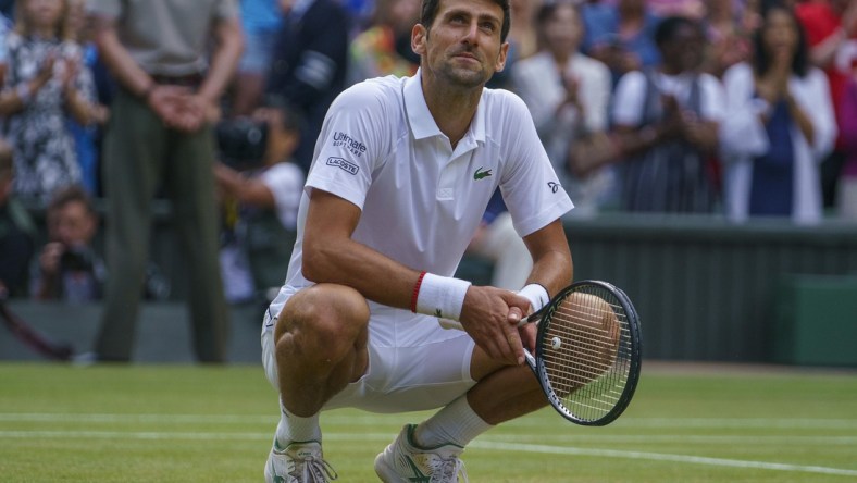 Jul 14, 2019; London, United Kingdom; Novak Djokovic (SRB) celebrates after match point against Roger Federer (SUI) during the mens final match on day 13 at the All England Lawn and Croquet Club. Mandatory Credit: Susan Mullane-USA TODAY Sports