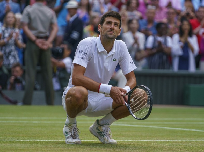 Jul 14, 2019; London, United Kingdom; Novak Djokovic (SRB) celebrates after match point against Roger Federer (SUI) during the mens final match on day 13 at the All England Lawn and Croquet Club. Mandatory Credit: Susan Mullane-USA TODAY Sports