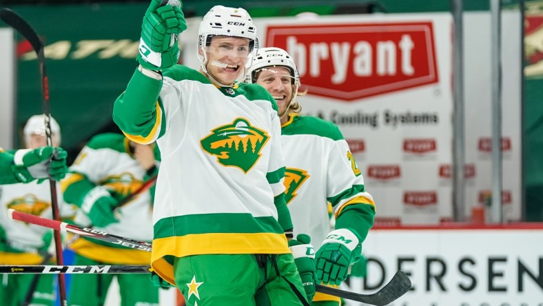 Jan 31, 2021; Saint Paul, Minnesota, USA; Minnesota Wild forward Nico Sturm (7) celebrates after an overtime goal by defenseman Jonas Brodin (not pictured) against the Colorado Avalanche at Xcel Energy Center. Mandatory Credit: Brace Hemmelgarn-USA TODAY Sports