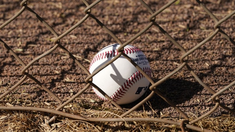 Feb 23, 2021; Scottsdale, Arizona, USA; A baseball resorts against the fence during spring training workouts at Salt River Fields at Talking Stick. Mandatory Credit: Rob Schumacher/Arizona Republic-USA TODAY Sports