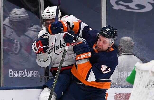 Apr 6, 2021; Uniondale, New York, USA; New York Islanders right wing Leo Komarov (47) checks Washington Capitals left wing Alex Ovechkin (8) into the boards during the second period between the New York Islanders and the Washington Capitals at Nassau Veterans Memorial Coliseum. Mandatory Credit: Dennis Schneidler-USA TODAY Sports