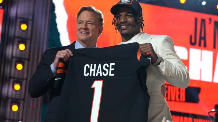 Apr 29, 2021; Cleveland, Ohio, USA; LSU Tigers wide receiver Ja'Marr Chase poses with NFL commissioner Roger Goodell after being selected as the fifth pick by the Cincinnati Bengals during the 2021 NFL Draft  at First Energy Stadium. Mandatory Credit: Kirby Lee-USA TODAY Sports