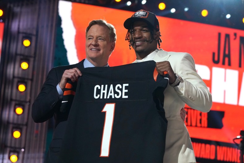 Apr 29, 2021; Cleveland, Ohio, USA; LSU Tigers wide receiver Ja'Marr Chase poses with NFL commissioner Roger Goodell after being selected as the fifth pick by the Cincinnati Bengals during the 2021 NFL Draft  at First Energy Stadium. Mandatory Credit: Kirby Lee-USA TODAY Sports