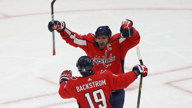 May 15, 2021; Washington, District of Columbia, USA; Washington Capitals left wing Alex Ovechkin (8) celebrates with Capitals center Nicklas Backstrom (19) after a goal by Capitals defenseman Brenden Dillon (not pictured) against the Boston Bruins in the second period in game one of the first round of the 2021 Stanley Cup Playoffs at Capital One Arena. Mandatory Credit: Geoff Burke-USA TODAY Sports