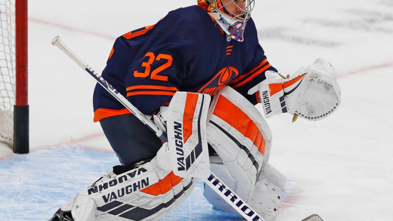 May 15, 2021; Edmonton, Alberta, CAN; Edmonton Oilers goaltender Alex Stalock (32) makes a save during warmup against the Vancouver Canucks at Rogers Place. Mandatory Credit: Perry Nelson-USA TODAY Sports