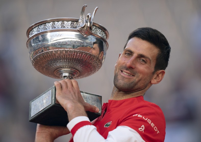 Jun 13, 2021; Paris, France; Novak Djokovic (SRB) poses with the trophy after winning the men's final against Stefanos Tsitsipas (GRE) on day 15 of the French Open at Stade Roland Garros. Mandatory Credit: Susan Mullane-USA TODAY Sports