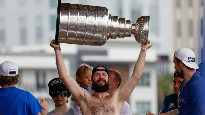 Jul 12, 2021; Tampa, FL, USA;  Tampa Bay Lightning right wing Nikita Kucherov (86) hoists the Stanley Cup during the Stanley Cup Championship parade. Mandatory Credit: Nathan Ray Seebeck-USA TODAY Sports