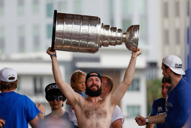 Jul 12, 2021; Tampa, FL, USA;  Tampa Bay Lightning right wing Nikita Kucherov (86) hoists the Stanley Cup during the Stanley Cup Championship parade. Mandatory Credit: Nathan Ray Seebeck-USA TODAY Sports