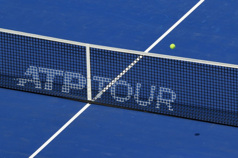 Aug 14, 2021; Mason, OH, USA; A view of the ATP Tour logo on the Center Court net as an official ball is in play during the Western and Southern Open tennis tournament at Lindner Family Tennis Center. Mandatory Credit: Aaron Doster-USA TODAY Sports