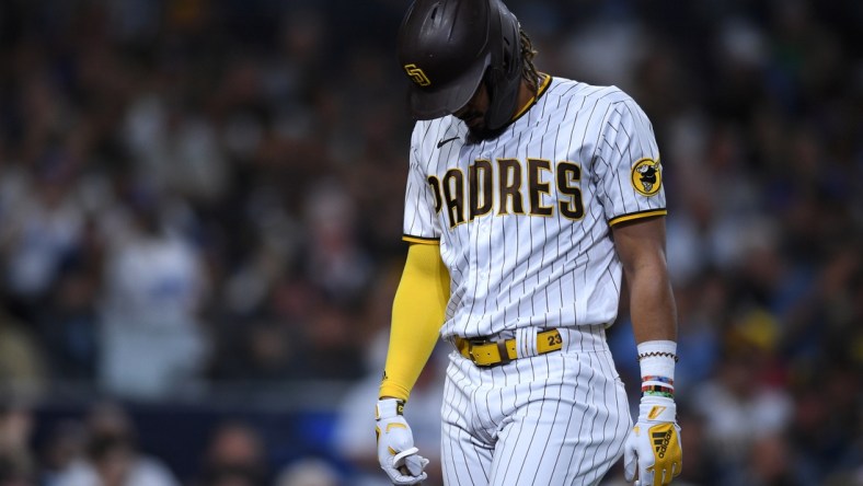 Aug 24, 2021; San Diego, California, USA; San Diego Padres center fielder Fernando Tatis Jr. (23) walks to the dugout after striking out during the fourth inning against the Los Angeles Dodgers at Petco Park. Mandatory Credit: Orlando Ramirez-USA TODAY Sports