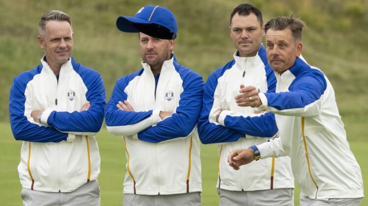 September 21, 2021; Kohler, Wisconsin, USA; Team Europe vice-captain Henrik Stenson (far right) tosses his hat as Luke Donald (far left), Graeme McDowell (second from left), and Martin Kaymer (third from left) look on while posing for a team photo during a practice round for the 43rd Ryder Cup golf competition at Whistling Straits. Mandatory Credit: Kyle Terada-USA TODAY Sports