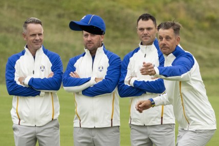 September 21, 2021; Kohler, Wisconsin, USA; Team Europe vice-captain Henrik Stenson (far right) tosses his hat as Luke Donald (far left), Graeme McDowell (second from left), and Martin Kaymer (third from left) look on while posing for a team photo during a practice round for the 43rd Ryder Cup golf competition at Whistling Straits. Mandatory Credit: Kyle Terada-USA TODAY Sports