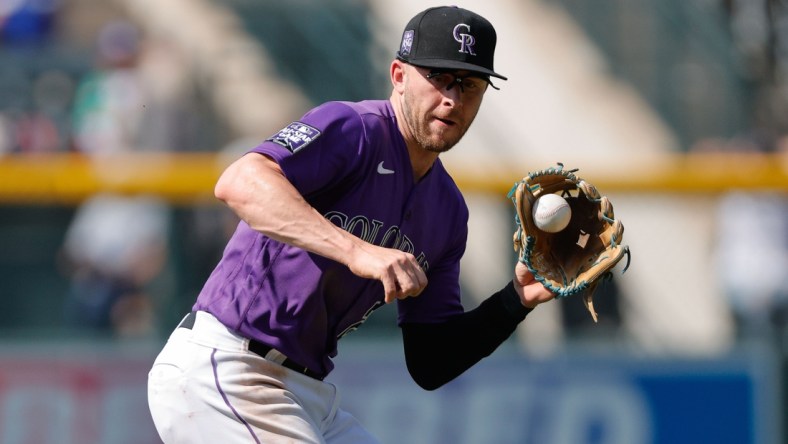 Sep 23, 2021; Denver, Colorado, USA; Colorado Rockies shortstop Trevor Story (27) fields the ball in the fourth inning against the Los Angeles Dodgers at Coors Field. Mandatory Credit: Isaiah J. Downing-USA TODAY Sports