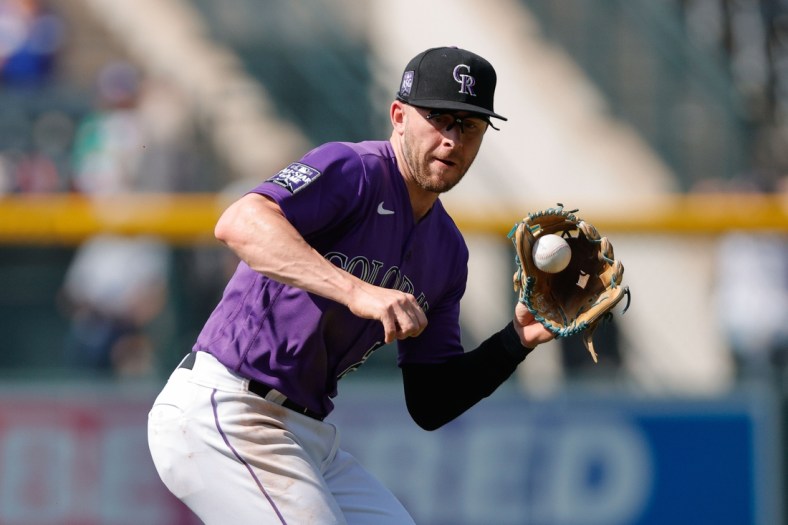 Sep 23, 2021; Denver, Colorado, USA; Colorado Rockies shortstop Trevor Story (27) fields the ball in the fourth inning against the Los Angeles Dodgers at Coors Field. Mandatory Credit: Isaiah J. Downing-USA TODAY Sports