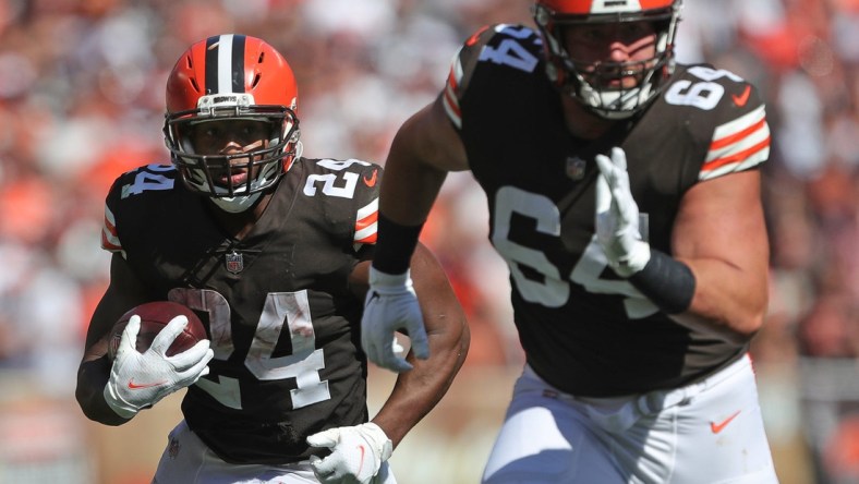 Cleveland Browns running back Nick Chubb (24) rushes for yards behind Cleveland Browns center JC Tretter (64) during the second half of an NFL football game against the Houston Texans, Sunday, Sept. 19, 2021, in Cleveland, Ohio.

Chubb 1