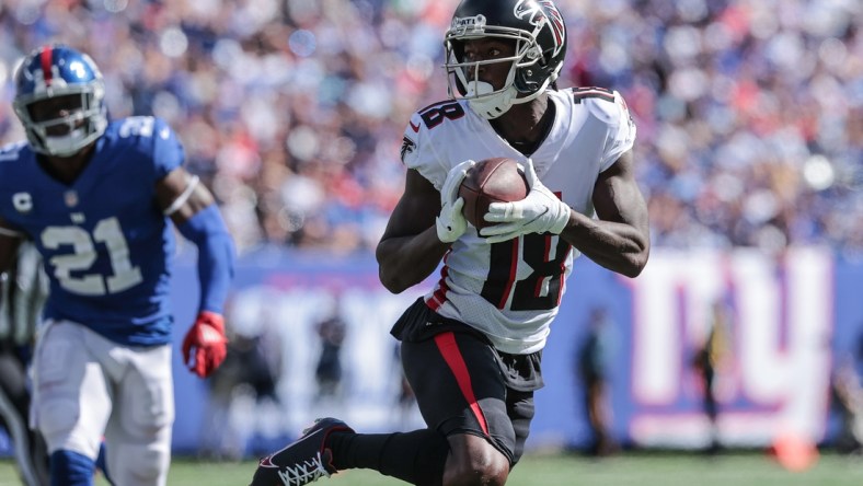 Sep 26, 2021; East Rutherford, New Jersey, USA; Atlanta Falcons wide receiver Calvin Ridley (18) carries the ball past New York Giants free safety Jabrill Peppers (21) during the first quarter at MetLife Stadium. Mandatory Credit: Vincent Carchietta-USA TODAY Sports