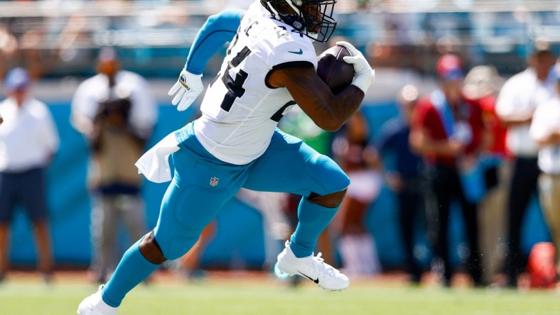 Sep 26, 2021; Jacksonville, Florida, USA; Jacksonville Jaguars running back Carlos Hyde (24) runs with the ball in the second quarter against the Arizona Cardinals at TIAA Bank Field. Mandatory Credit: Nathan Ray Seebeck-USA TODAY Sports