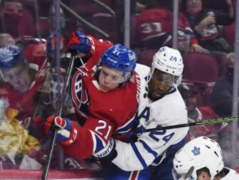 Sep 27, 2021; Montreal, Quebec, CAN; Toronto Maple Leafs forward Wayne Simmonds (24) checks Montreal Canadiens defenseman Kaiden Guhle (21) during the third period at the Bell Centre. Mandatory Credit: Eric Bolte-USA TODAY Sports