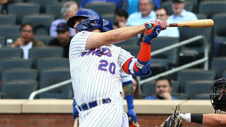 Sep 28, 2021; New York City, New York, USA; New York Mets first baseman Pete Alonso (20) singles against the Miami Marlins during the first inning of game one of a doubleheader at Citi Field. Mandatory Credit: Andy Marlin-USA TODAY Sports