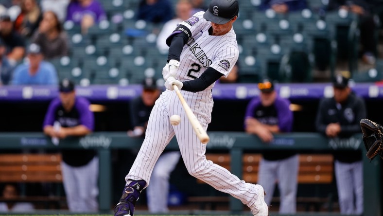 Sep 29, 2021; Denver, Colorado, USA; Colorado Rockies third baseman Ryan McMahon (24) hits a three run home run in the first inning against the Washington Nationals at Coors Field. Mandatory Credit: Isaiah J. Downing-USA TODAY Sports