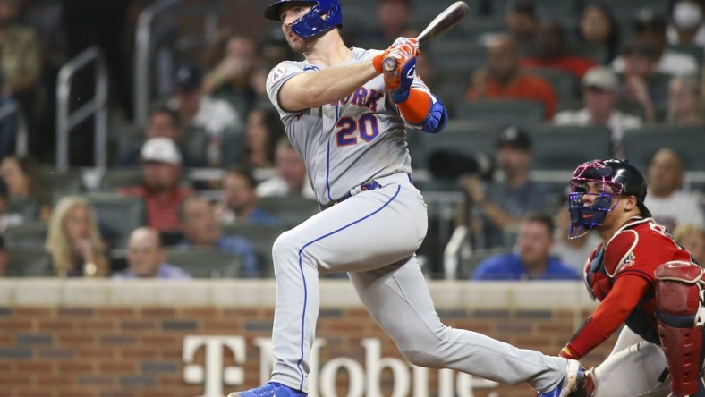 Oct 1, 2021; Atlanta, Georgia, USA; New York Mets first baseman Pete Alonso (20) hits a double against the Atlanta Braves in the fourth inning at Truist Park. Mandatory Credit: Brett Davis-USA TODAY Sports