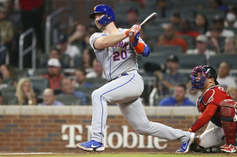 Oct 1, 2021; Atlanta, Georgia, USA; New York Mets first baseman Pete Alonso (20) hits a double against the Atlanta Braves in the fourth inning at Truist Park. Mandatory Credit: Brett Davis-USA TODAY Sports