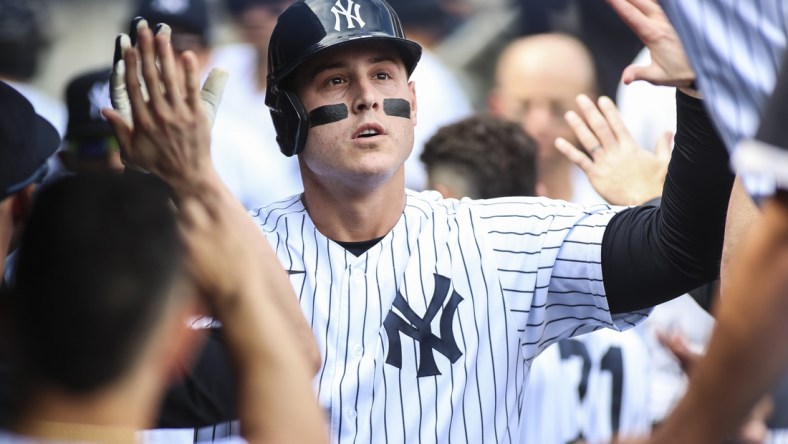 Oct 2, 2021; Bronx, New York, USA;  New York Yankees first baseman Anthony Rizzo (48) is greeted in the dugout after hitting a solo home run in the first inning against the Tampa Bay Rays at Yankee Stadium. Mandatory Credit: Wendell Cruz-USA TODAY Sports