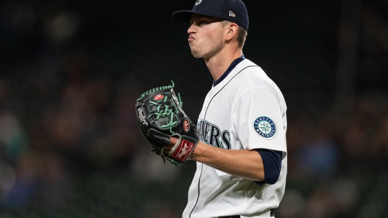 Sep 27, 2021; Seattle, Washington, USA;  Seattle Mariners starting pitcher Chris Flexen (77) reacts during a game against the Oakland Athletics at T-Mobile Park. The Mariners won 13-4. Mandatory Credit: Stephen Brashear-USA TODAY Sports