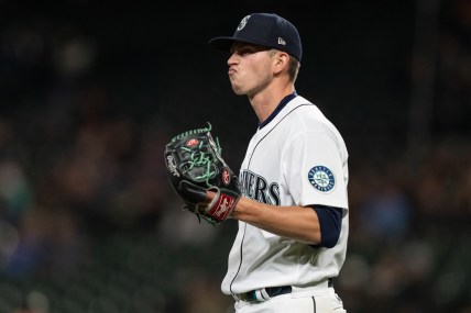 Sep 27, 2021; Seattle, Washington, USA;  Seattle Mariners starting pitcher Chris Flexen (77) reacts during a game against the Oakland Athletics at T-Mobile Park. The Mariners won 13-4. Mandatory Credit: Stephen Brashear-USA TODAY Sports