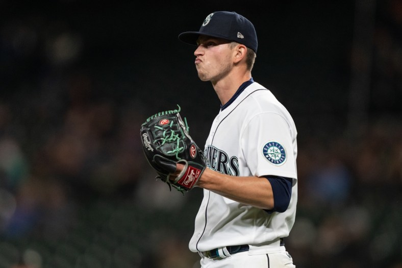Sep 27, 2021; Seattle, Washington, USA;  Seattle Mariners starting pitcher Chris Flexen (77) reacts during a game against the Oakland Athletics at T-Mobile Park. The Mariners won 13-4. Mandatory Credit: Stephen Brashear-USA TODAY Sports